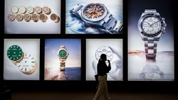 A visitor walks past photographs at the stand of Swiss luxury watchmaker Rolex during the opening day of the "Watches and Wonders Geneva" luxury watch fair, in Geneva, on April 14, 2026. The Geneva watch fair opened on April 14 and will be taken as a barometer of how the Middle East war is affecting the luxury goods sector. The Watches and Wonders salon -- the industry's biggest annual event -- sees 65 major watch brands, including Rolex, Patek Philippe, Cartier and Bulgari, display their latest creations until April 20. (Photo by Fabrice COFFRINI / AFP)
A visitor walks past photographs at the stand of Swiss luxury watchmaker Rolex during the opening day of the "Watches and Wonders Geneva" luxury watch fair, in Geneva, on April 14, 2026. The Geneva watch fair opened on April 14 and will be taken as a barometer of how the Middle East war is affecting the luxury goods sector. The Watches and Wonders salon -- the industry's biggest annual event -- sees 65 major watch brands, including Rolex, Patek Philippe, Cartier and Bulgari, display their latest creations until April 20. (Photo by Fabrice COFFRINI / AFP) A visitor walks past photographs at the stand of Swiss luxury watchmaker Rolex during the opening day of the "Watches and Wonders Geneva" luxury watch fair, in Geneva, on April 14, 2026. The Geneva watch fair opened on April 14 and will be taken as a barometer of how the Middle East war is affecting the luxury goods sector. The Watches and Wonders salon -- the industry's biggest annual event -- sees 65 major watch brands, including Rolex, Patek Philippe, Cartier and Bulgari, display their latest creations until April 20. (Photo by Fabrice COFFRINI / AFP)