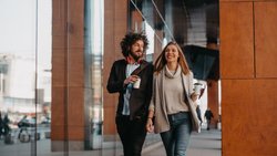 Business,Man,And,Business,Woman,Talking,And,Holding,Luggage,Traveling