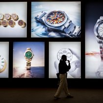 A visitor walks past photographs at the stand of Swiss luxury watchmaker Rolex during the opening day of the "Watches and Wonders Geneva" luxury watch fair, in Geneva, on April 14, 2026. The Geneva watch fair opened on April 14 and will be taken as a barometer of how the Middle East war is affecting the luxury goods sector. The Watches and Wonders salon -- the industry's biggest annual event -- sees 65 major watch brands, including Rolex, Patek Philippe, Cartier and Bulgari, display their latest creations until April 20. (Photo by Fabrice COFFRINI / AFP)
A visitor walks past photographs at the stand of Swiss luxury watchmaker Rolex during the opening day of the "Watches and Wonders Geneva" luxury watch fair, in Geneva, on April 14, 2026. The Geneva watch fair opened on April 14 and will be taken as a barometer of how the Middle East war is affecting the luxury goods sector. The Watches and Wonders salon -- the industry's biggest annual event -- sees 65 major watch brands, including Rolex, Patek Philippe, Cartier and Bulgari, display their latest creations until April 20. (Photo by Fabrice COFFRINI / AFP) A visitor walks past photographs at the stand of Swiss luxury watchmaker Rolex during the opening day of the "Watches and Wonders Geneva" luxury watch fair, in Geneva, on April 14, 2026. The Geneva watch fair opened on April 14 and will be taken as a barometer of how the Middle East war is affecting the luxury goods sector. The Watches and Wonders salon -- the industry's biggest annual event -- sees 65 major watch brands, including Rolex, Patek Philippe, Cartier and Bulgari, display their latest creations until April 20. (Photo by Fabrice COFFRINI / AFP)