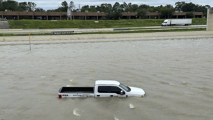 Béryl, situé actuellement au Texas, a été rétrogradé lundi en tempête tropicale. Ici, une voiture submergée à Houston.